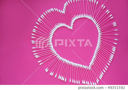 cotton buds laid out in the shape of a heart on a 49351592
