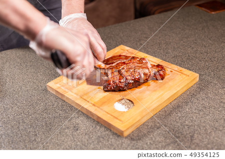 food, delicious and craft concept - serving of grilled meat steak 49354125