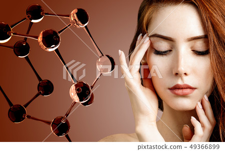 Beautiful redehead woman near big white molecule structure. Beautiful redehead woman near big white molecule structure. 49366899
