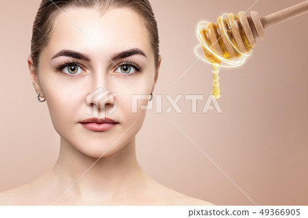 Young woman and honey spoon prepare for facial mask. 49366905