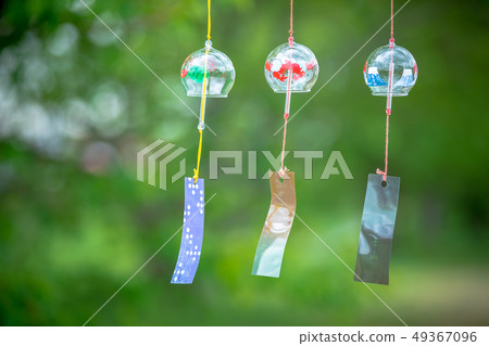 Several glass wind bells swaying in the wind 49367096