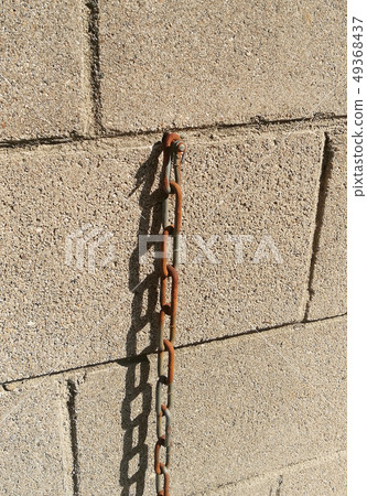 Lonely rusted chain image on a brick Lonely rusted chain image on a brick 49368437
