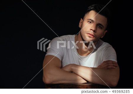Handsome man portrait ray of light on his face 49369285