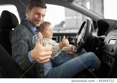 Caring father sitting with son in new comfortable auto 49369722