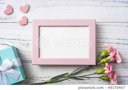 top view of carnation with photo frame on white top view of carnation with photo frame on white 49370467