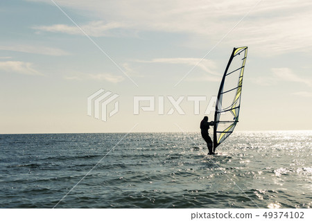 Surfing at the sunset of the sea. An Active 49374102