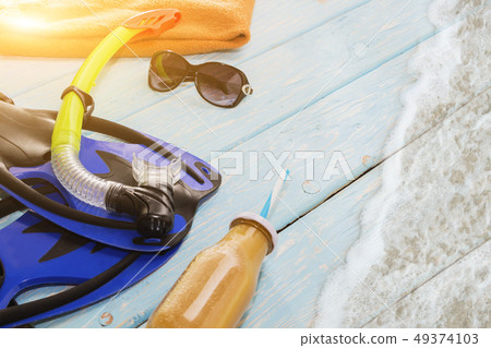 blue fins and snorkel for swimming on light blue 49374103