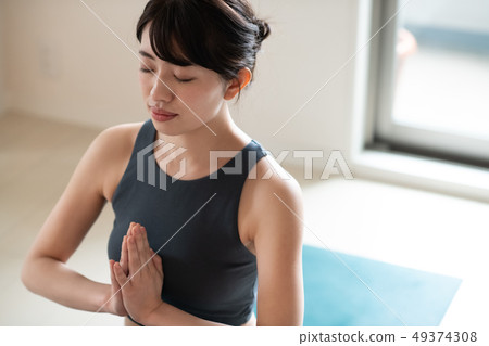 Young woman doing yoga Japanese meditation concentration 49374308