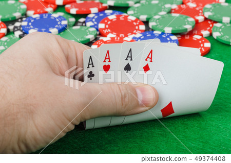 Hand with playing cards in casino 49374408