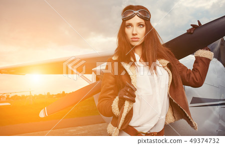 Portrait of young beautiful woman pilot in front Portrait of young beautiful woman pilot in front 49374732