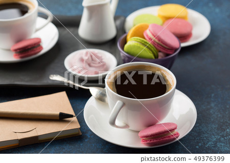 Two cups of coffee and sweets on table 49376399