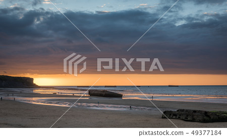 Sun setting on Arromaches landing beach 49377184
