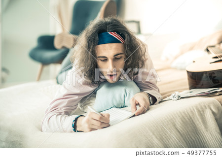 Inspired thoughtful musician having productive period in creation 49377755