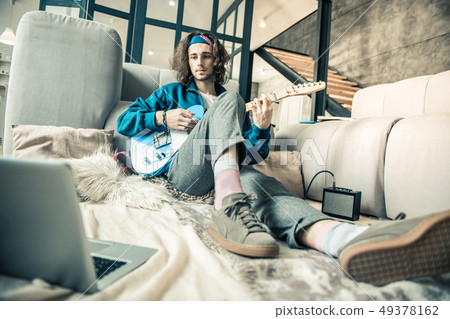 Attentive dark-haired talented guy experimenting with sounds 49378162