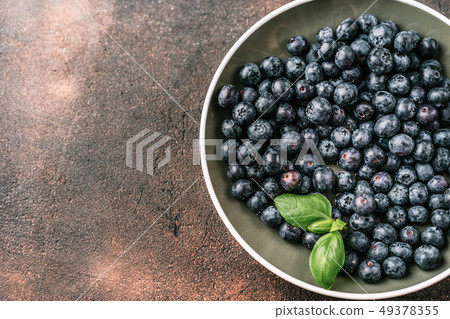 Fresh blueberries in a cup on white background Fresh blueberries in a cup on white background 49378355