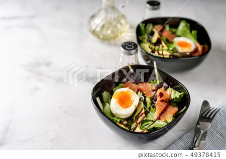 Green salad with egg and salmon for breakfast Green salad with egg and salmon for breakfast 49378415