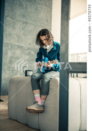 Handsome young man being professional musician and playing at home 49378745