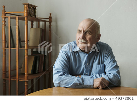 Elderly businessman sitting thinking deeply 49378801
