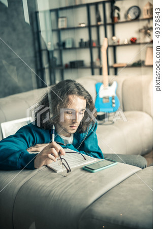 Peaceful good-looking guy taking off glasses and pondering his work 49378843