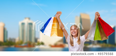 Shopping smiling woman holding shopping bags Shopping smiling woman holding shopping bags 49379388