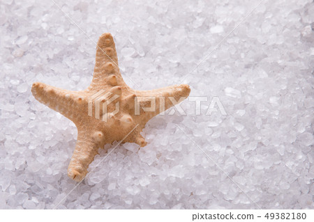 Starfish lying in crystals of white sea salt. 49382180
