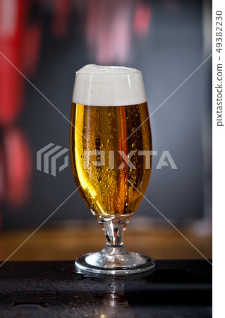 Glass of beer on the dark background Glass of beer on the dark background 49382230