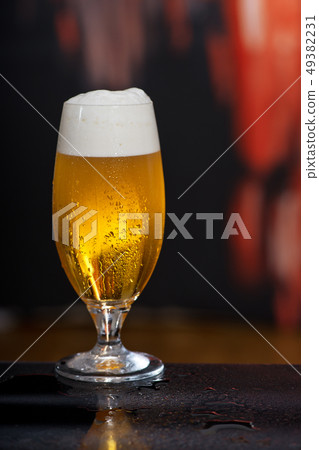 Glass of beer on the dark background Glass of beer on the dark background 49382231