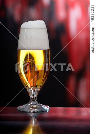 Glass of beer on the dark background Glass of beer on the dark background 49382232