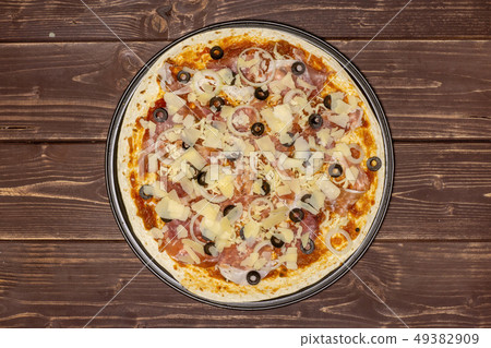 Recipe of pizza capriciosa on brown wood Recipe of pizza capriciosa on brown wood 49382909