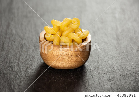 Cavatappi pasta raw on grey stone Cavatappi pasta raw on grey stone 49382981
