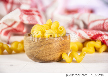 Cavatappi pasta raw with kitchen behind 49382989