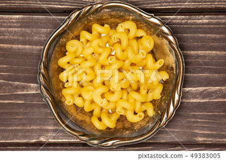 Cavatappi pasta raw on brown wood 49383005