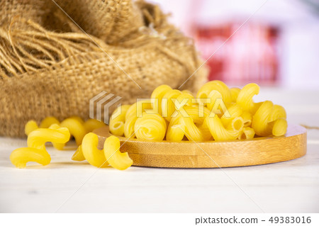 Cavatappi pasta raw with kitchen behind 49383016