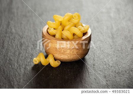 Cavatappi pasta raw on grey stone 49383021