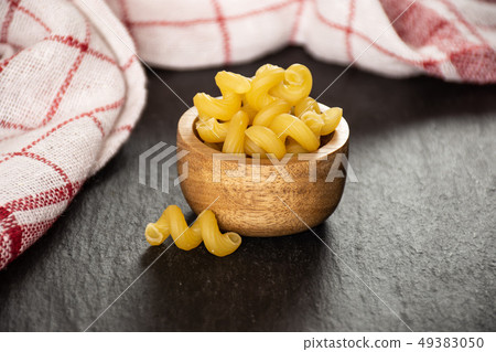 Cavatappi pasta raw on grey stone 49383050