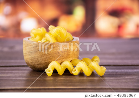 Cavatappi pasta raw with rustic kitchen 49383067