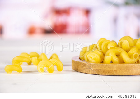 Cavatappi pasta raw with kitchen behind 49383085