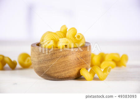 Cavatappi pasta raw with kitchen behind Cavatappi pasta raw with kitchen behind 49383093