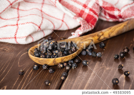 Dry juniper berries on brown wood 49383095