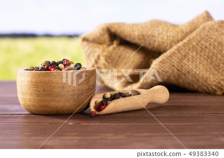 Four colors of peppercorns with field behind Four colors of peppercorns with field behind 49383340