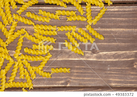 Raw italian torti pasta on brown wood 49383372