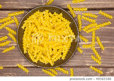 Raw italian torti pasta on brown wood 49383386