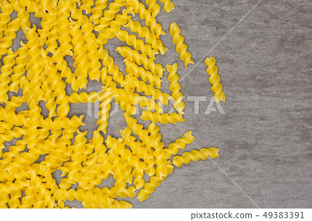 Raw italian torti pasta on grey stone Raw italian torti pasta on grey stone 49383391