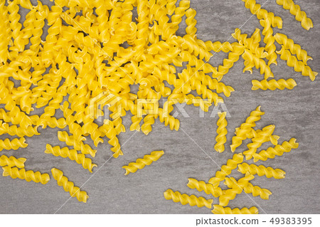 Raw italian torti pasta on grey stone Raw italian torti pasta on grey stone 49383395