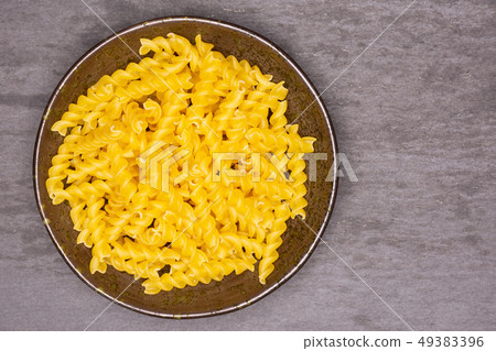 Raw italian torti pasta on grey stone Raw italian torti pasta on grey stone 49383396