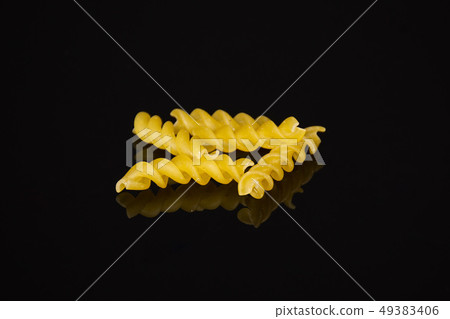 Raw italian torti pasta isolated on black glass 49383406