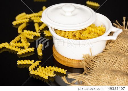 Raw italian torti pasta on black glass Raw italian torti pasta on black glass 49383407