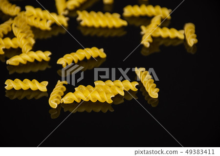 Raw italian torti pasta on black glass 49383411
