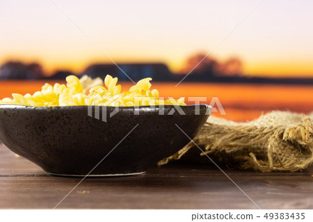 Raw italian torti pasta with autumn field behind 49383435