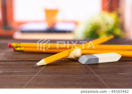 Yellow simple pencil with books on window Yellow simple pencil with books on window 49383482